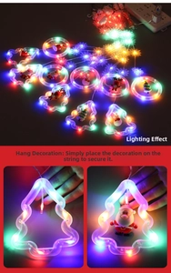 Detail of colorful LED Christmas string lights with Santa and snowman figurines inside