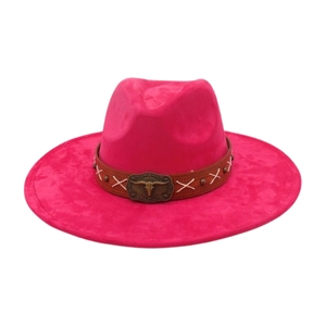 Detail of rose red suede cowboy hat featuring brown leather band and bull skull buckle