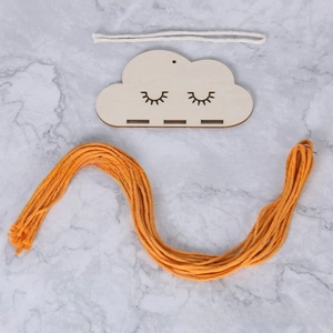 DIY cloud wall hanging kit with wooden base and vibrant orange yarn for home decor
