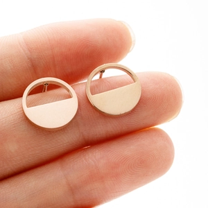 Detailed close-up of minimalist rose gold geometric hoop earrings with polished finish