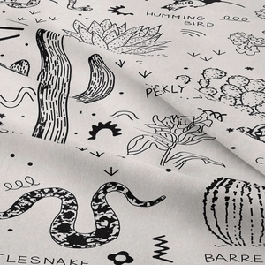 Macro detail of Bohemian tapestry showing soft fabric texture and desert hand-drawn prints
