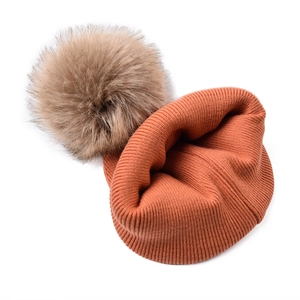 Caramel knit baby beanie with large fluffy faux fur pom pom for autumn and winter