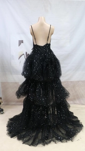 Detail of black starry mesh gown with silver star sequins and tiered backless design