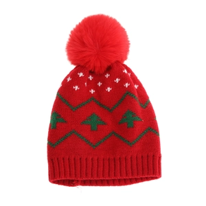 Red knit Christmas hat for kids with green tree patterns and a large fluffy pom-pom