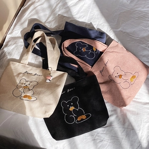 Corduroy tote bags with bear embroidery in cream, black, pink, and navy blue