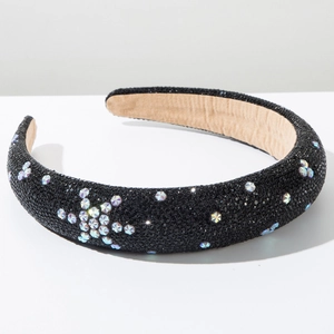 Close-up of padded black sponge headband with sparkling rhinestone star patterns