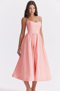 Detail shot of the backless design and thin straps on a pink summer midi dress
