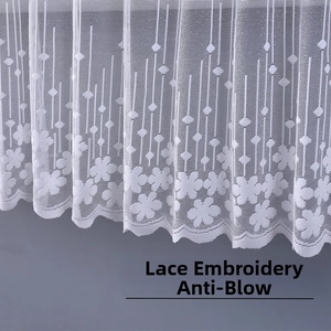 Close-up of white lace embroidery cabinet curtain with floral patterns and scalloped edges