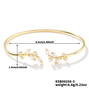 Detail view of gold willow leaf bangle with cubic zirconia inlay and measurements