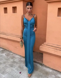 Détails de la texture d'une robe longue en satin bleu-vert avec col en V élégant