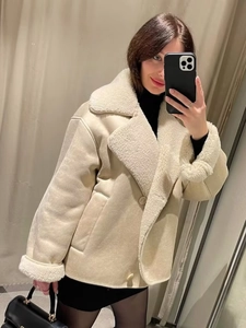 Women's cream shearling jacket with faux fur lapels and button closure for winter