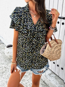 Detail of V-neck floral blouse featuring ruffle sleeves on a casual black printed top