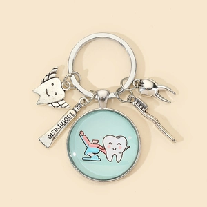 Detail of dental keychain featuring a toothbrush, toothpaste, and wing tooth charm