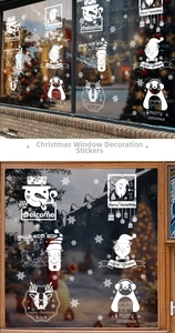 Detail showing white static Christmas window stickers with Santa and snowman patterns