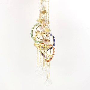 Detail of sun and moon crystal suncatchers with natural stones and prisms hanging