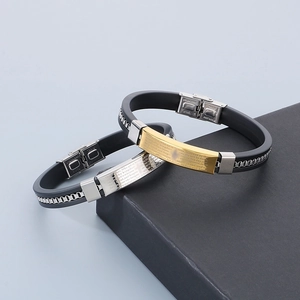 Detail of stainless steel men's bracelets with engraved Lord's Prayer on silicone bands