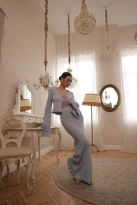 Macro view of light blue hollow crochet texture on knit top and mermaid skirt