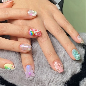 Macro shot of 3D bear and lollipop nail charms on Y2K style colorful manicured nails