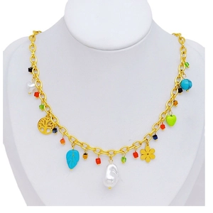 Gold chain necklace with irregular pearl, turquoise leaves, and colorful charms on mannequin