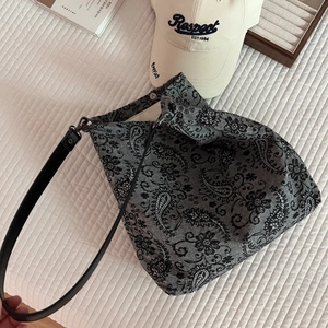 Detail of grey paisley embroidery canvas tote bag with magnetic metal clasp and strap