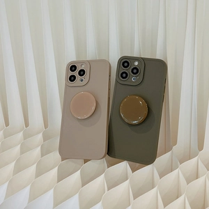 Detail view of beige and army green silicone phone cases with matching kickstand