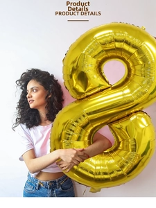Detail of a shiny gold foil number 8 balloon with metallic finish held by a person