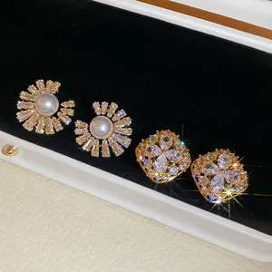 Elegant gold plated pearl earrings with zircon sunburst and floral geometric designs