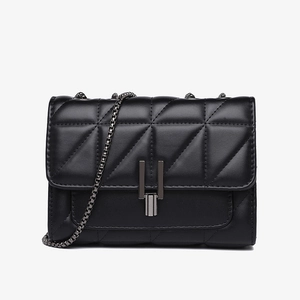 Detailed close-up of black quilted leather texture and dark gray metal square lock