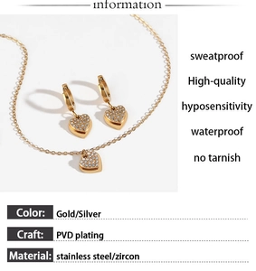 Macro detail of gold heart necklace and earrings set with zircons and product features