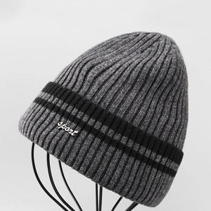 Detailed view of the sport embroidery on the gray and black ribbed winter knit hat