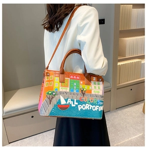 Detail of colorful Portofino city print handbag with brown leather straps and embroidery