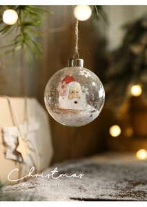 Detail of 8cm clear glass Christmas ball with Santa Claus figurine and snowflakes