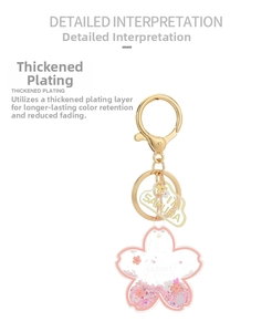 Detail of cherry blossom acrylic keychain with pink liquid glitter and gold plating