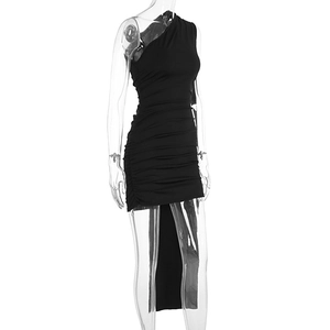 Detail of black one-shoulder dress featuring ruched texture and elegant long trailing sash