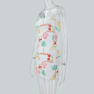 Detail view of tube dress with summer prints of cherries, palms and shells on white fabric