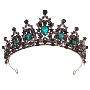 Close-up of gold bridal headband with green teardrop crystals and black rhinestones