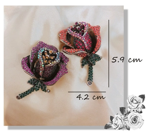 Detail view of crystal rose brooches in purple and orange with precise size dimensions