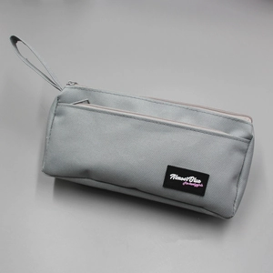 Detail view of the gray oxford cloth stationery bag with zip and Almost Blue logo