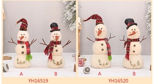 Detail of linen Christmas snowmen figurines with red plaid and black top hats