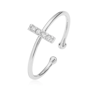 Macro detail of silver open ring with cubic zirconia inlay on a white background