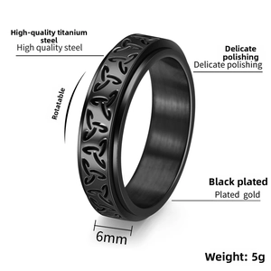 Macro view of 6mm black spinner ring with Celtic knot engraving and polished steel edges