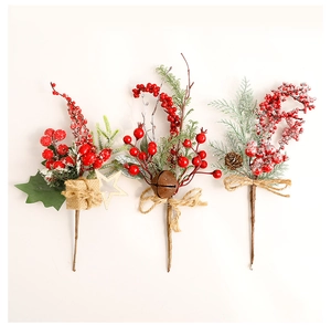 Three assorted Christmas berry picks with pine cones, rusted bells, and mini gift boxes