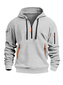 Detail of light grey hoodie featuring half-zip collar and orange zipper puller detail