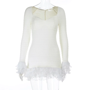 Macro shot of ivory long-sleeve dress featuring textured pleats and ruffled edge details