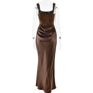 Detail of waist ruching on a dark brown satin bodycon dress with elegant draping effect