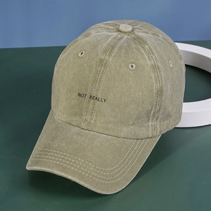 Close-up of NOT REALLY embroidery on vintage washed cotton green baseball cap