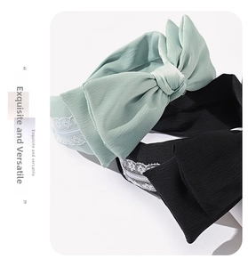 Detail of mint green and black bow headbands with delicate floral lace trim textures