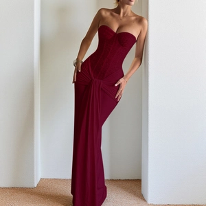 Deep burgundy strapless evening gown featuring a shimmering bodice and flowing long skirt