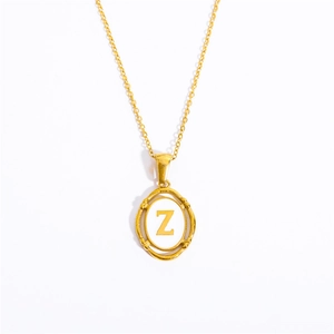 Macro shot of gold stainless steel necklace featuring an oval pendant with letter Z