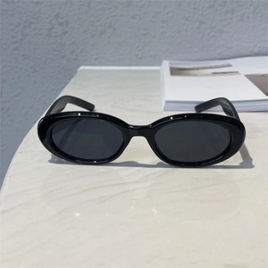 Detail of classic black oval frame sunglasses with high-quality polished surface